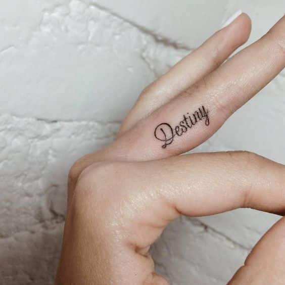 tatuaje de letra en el dedo